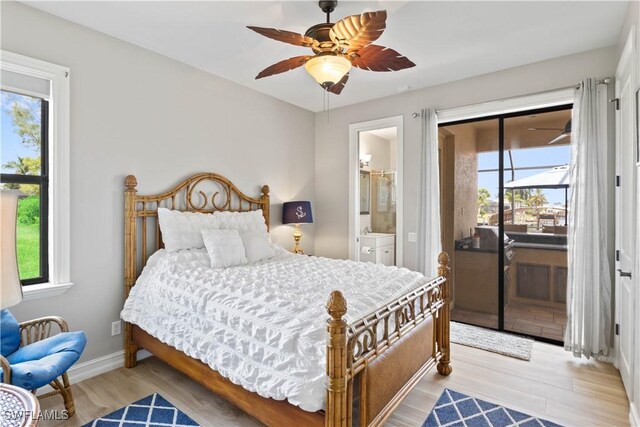 bedroom featuring ceiling fan, multiple windows, light wood-type flooring, and ensuite bath