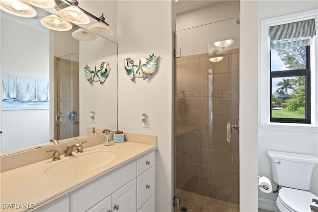 full bathroom with a stall shower, vanity, and toilet