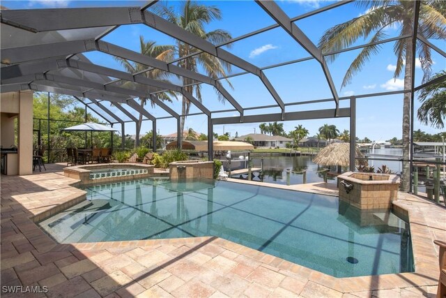 view of pool with a lanai, a water view, an in ground hot tub, and a patio area