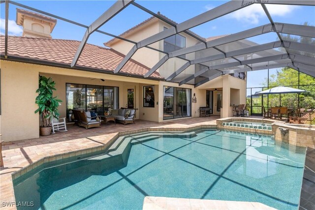 view of swimming pool with glass enclosure, an outdoor hangout area, a patio area, and an in ground hot tub