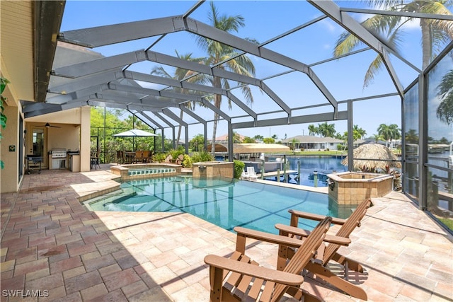 view of pool with glass enclosure, a patio area, and an in ground hot tub