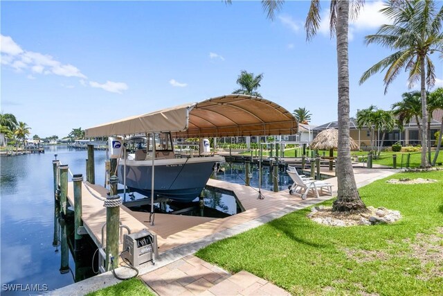 view of dock with a yard, a water view, and boat lift