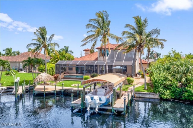 view of dock with boat lift, a lanai, a water view, a yard, and an outdoor pool