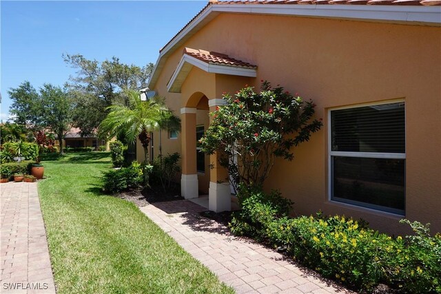 view of side of property with a yard