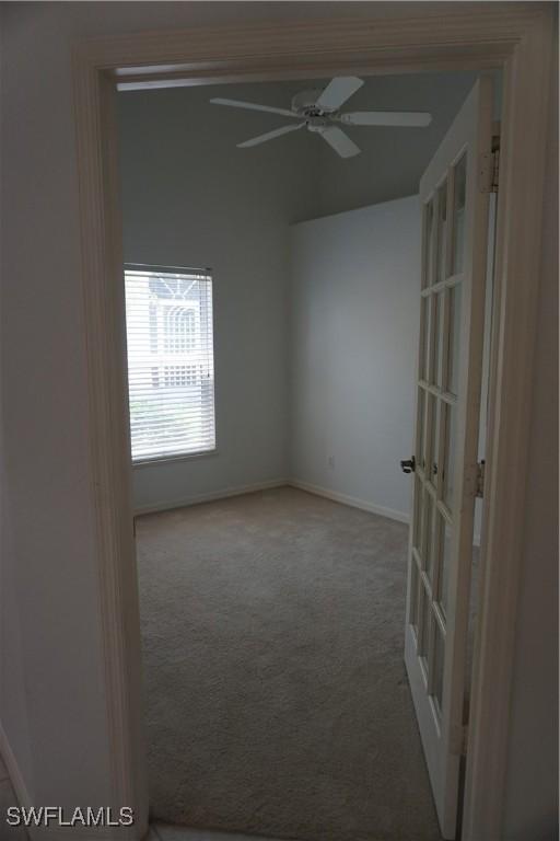 carpeted empty room with ceiling fan