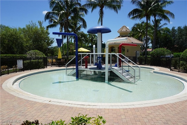 view of playground with a community pool