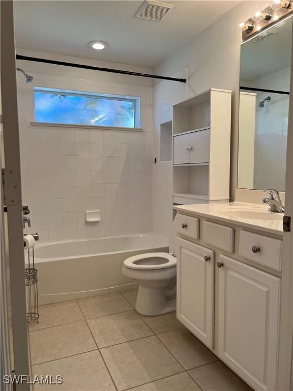 full bathroom with tile patterned flooring, vanity, toilet, and tiled shower / bath