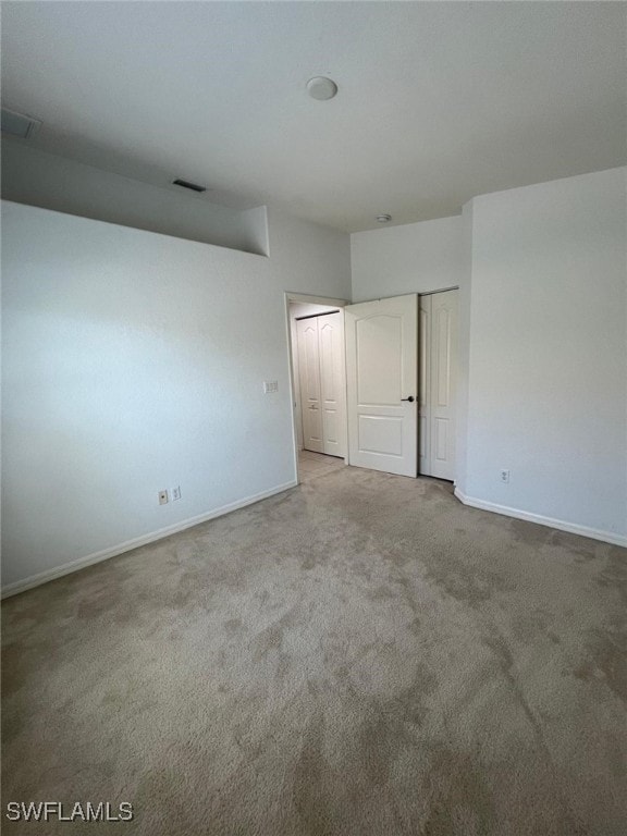 unfurnished bedroom featuring light colored carpet