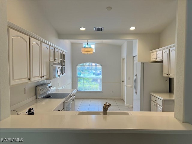 kitchen featuring light tile patterned flooring, sink, decorative light fixtures, kitchen peninsula, and white appliances