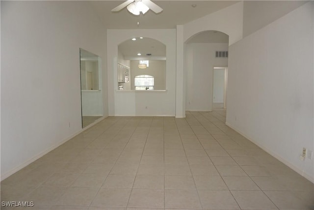 spare room featuring light tile patterned flooring and ceiling fan