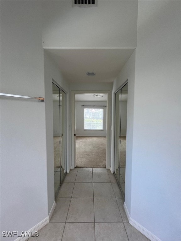 hallway featuring light tile patterned flooring