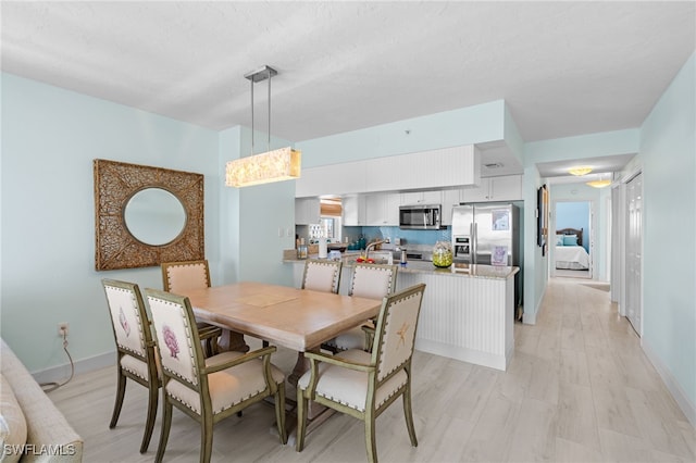 dining space featuring light hardwood / wood-style flooring