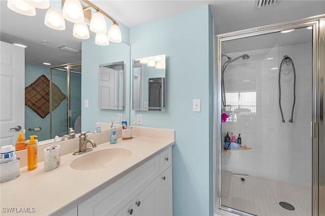 bathroom with an enclosed shower and vanity