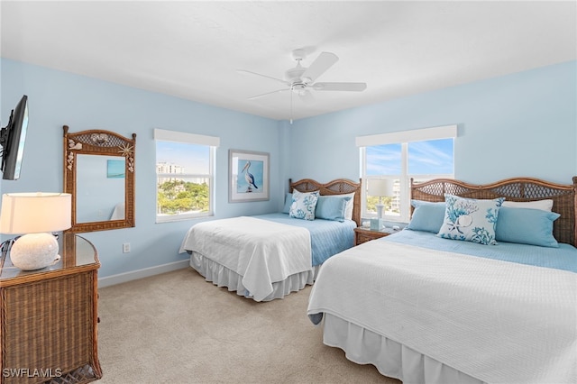 bedroom featuring ceiling fan and light carpet