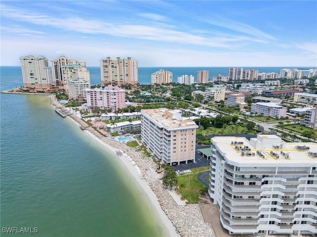 drone / aerial view with a beach view and a water view