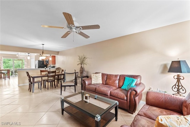 4965 Sandra Bay Dr Unit 103, Naples, FL 34109 - living area featuring a ceiling fan, light tile patterned floors, and baseboards