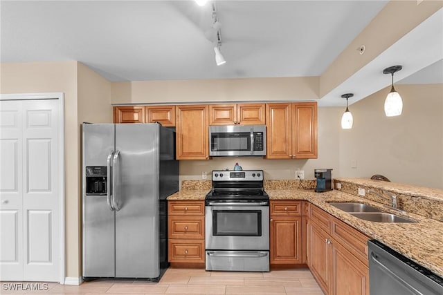 4965 Sandra Bay Dr Unit 103, Naples, FL 34109 - kitchen with appliances with stainless steel finishes, light stone countertops, a sink, pendant lighting, and wood tiled floors