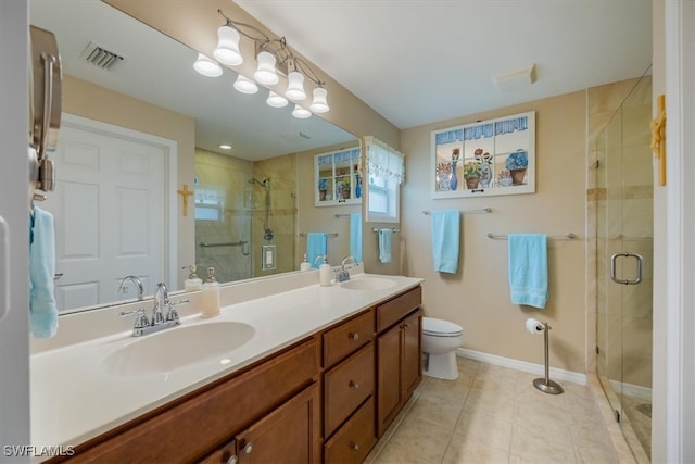 bathroom with tile patterned floors, walk in shower, toilet, and vanity