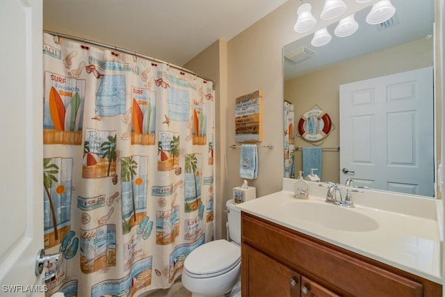 bathroom featuring vanity, toilet, and a shower with curtain