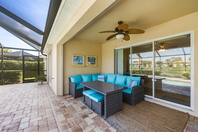 view of patio / terrace with glass enclosure, ceiling fan, and an outdoor hangout area