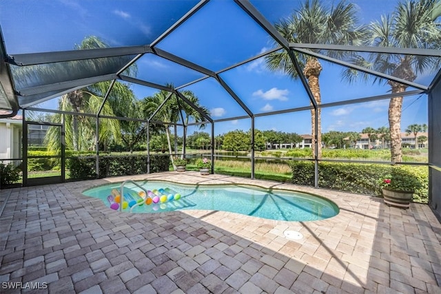 view of swimming pool with a lanai and a patio