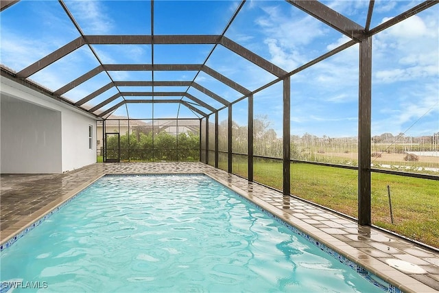 view of swimming pool with a patio area, a lanai, and a yard