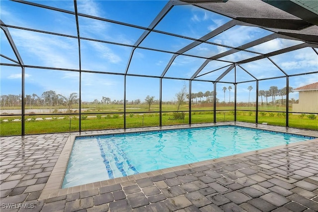 view of swimming pool with glass enclosure and a patio area