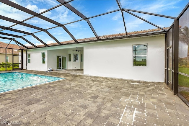 view of swimming pool featuring a patio area, ceiling fan, and a lanai