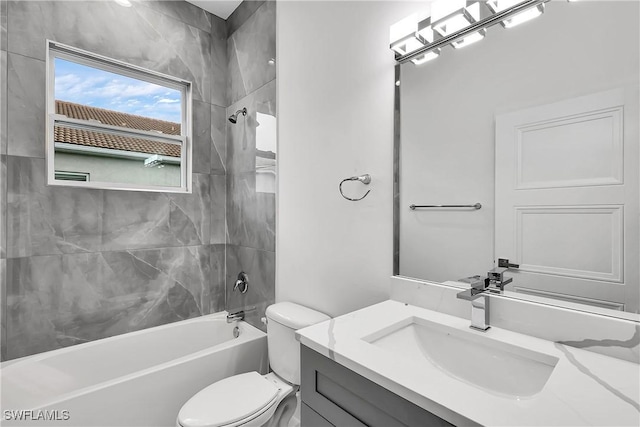 full bathroom featuring vanity, toilet, and tiled shower / bath