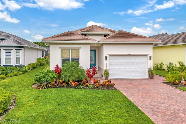 mediterranean / spanish house featuring a garage and a front lawn