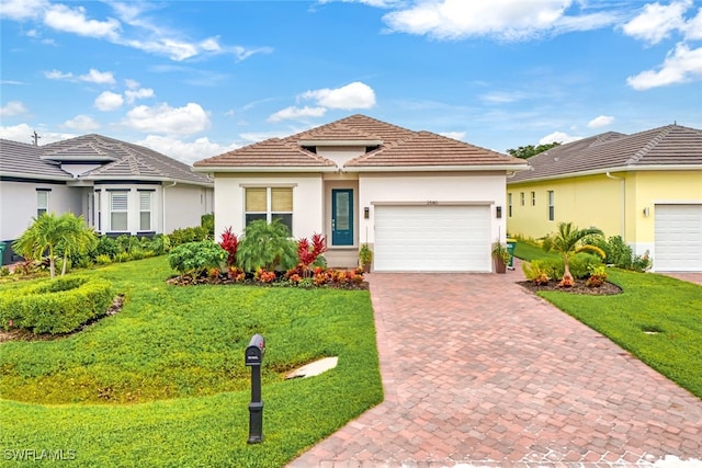 mediterranean / spanish-style home with a garage and a front lawn