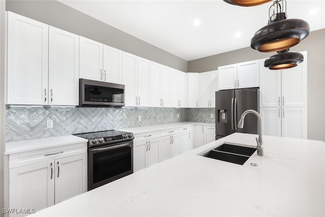 kitchen featuring sink, white cabinetry, and stainless steel appliances