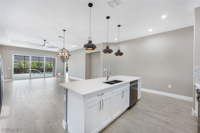 kitchen with white cabinets, sink, stainless steel dishwasher, an island with sink, and light hardwood / wood-style floors