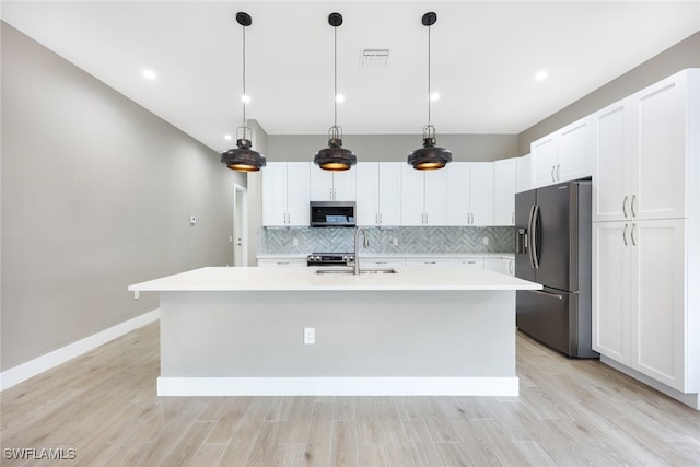 kitchen with white cabinetry, sink, an island with sink, and appliances with stainless steel finishes