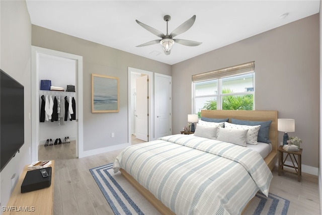 bedroom featuring ensuite bathroom, light hardwood / wood-style floors, a closet, and ceiling fan