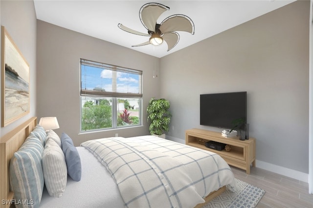 bedroom with light hardwood / wood-style flooring and ceiling fan