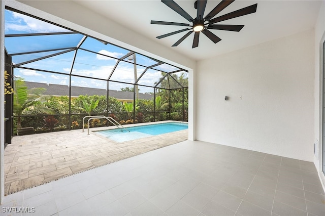 view of swimming pool with a lanai, ceiling fan, and a patio area