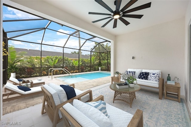 view of swimming pool featuring outdoor lounge area, a patio, glass enclosure, and ceiling fan