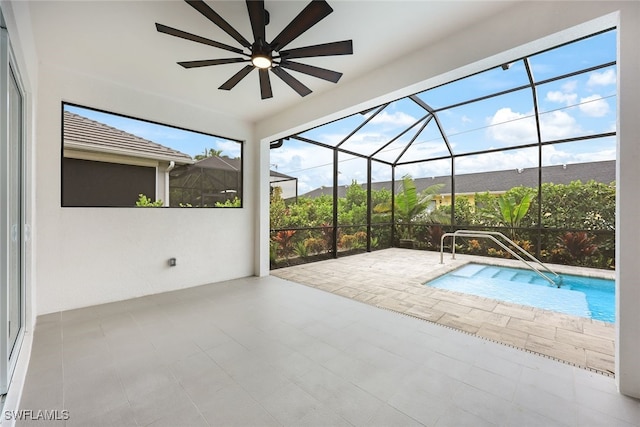 view of pool with a lanai, ceiling fan, and a patio area