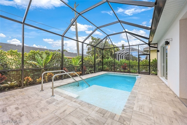 view of swimming pool featuring a lanai and a patio