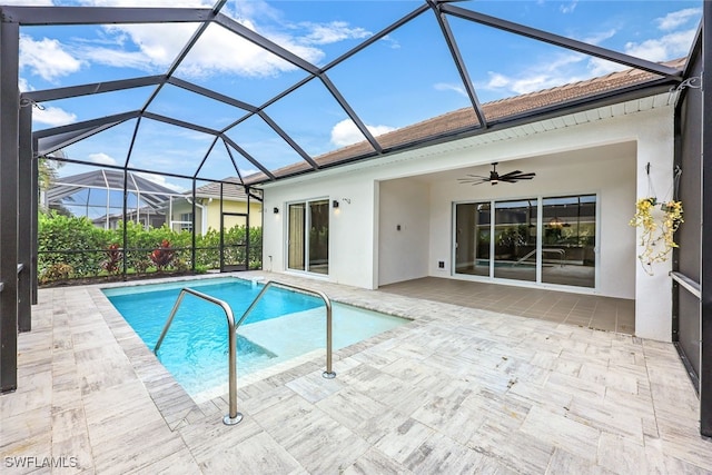 view of pool with a lanai, ceiling fan, and a patio