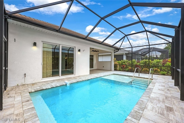 view of pool featuring ceiling fan, a patio area, and a lanai