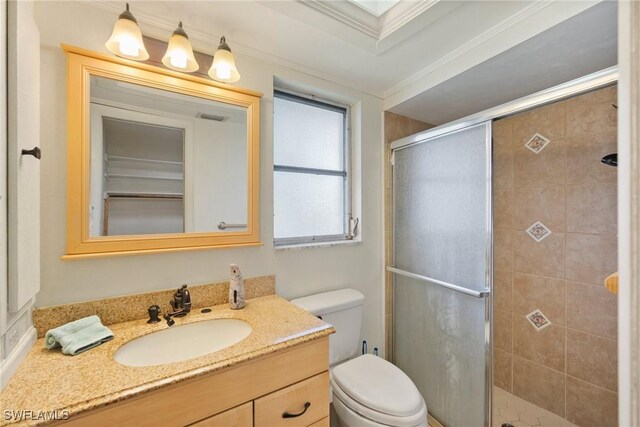 full bath with visible vents, toilet, ornamental molding, vanity, and a shower stall