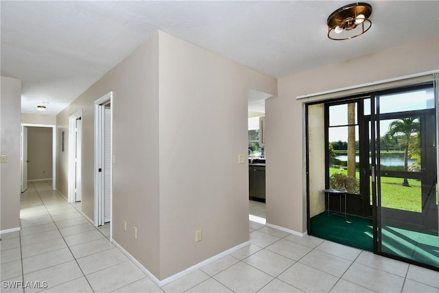 interior space with a water view and light tile patterned flooring