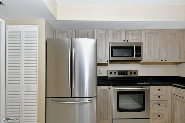 kitchen featuring light brown cabinets and stainless steel appliances