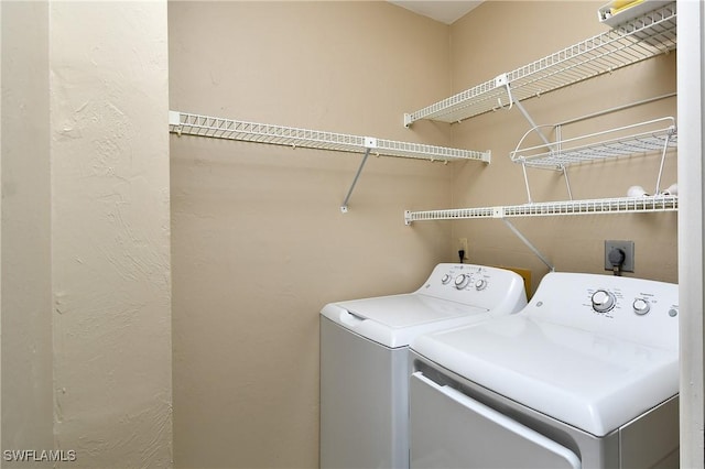 laundry room with washing machine and dryer