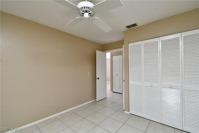 unfurnished bedroom featuring light tile patterned floors, ceiling fan, and a closet