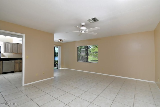 tiled empty room featuring ceiling fan