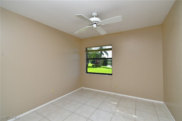 tiled empty room featuring ceiling fan