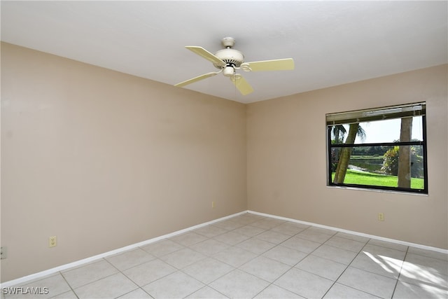 tiled spare room with ceiling fan